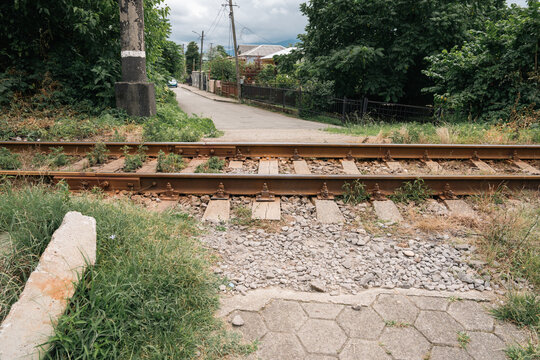 A railway in the countryside surrounded by bushes and trees