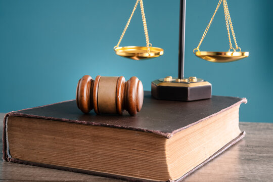 The judge holds the verdict in one hand and the gavel in the other, with scales symbolizing justice, power and legal decision-making.