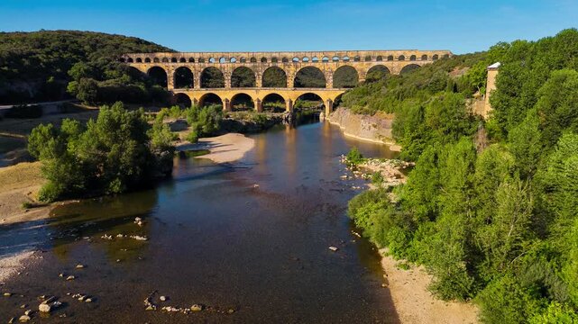 Aerial drone view of the Pont du Gard, the tallest surviving ancient Roman aqueduct from the 1st century with three tiers of arches, France. High quality 4k footage