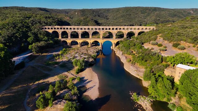 Aerial drone view of the Pont du Gard, the tallest surviving ancient Roman aqueduct from the 1st century with three tiers of arches, France. High quality 4k footage