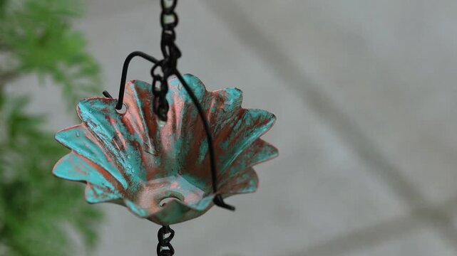 Slow Motion Raindrop Falling into Vintage Copper Rain Chain Cup