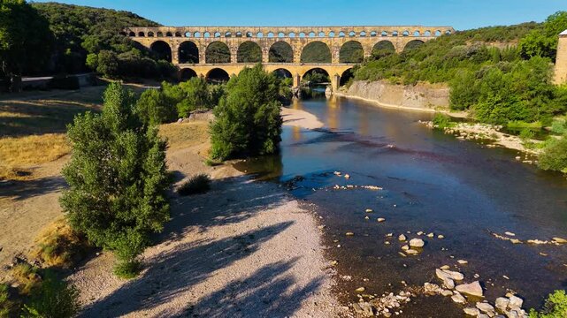 Aerial drone view of the Pont du Gard, the tallest surviving ancient Roman aqueduct from the 1st century with three tiers of arches, France. High quality 4k footage