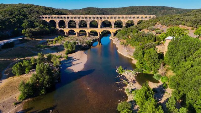 Aerial drone view of the Pont du Gard, the tallest surviving ancient Roman aqueduct from the 1st century with three tiers of arches, France. High quality 4k footage