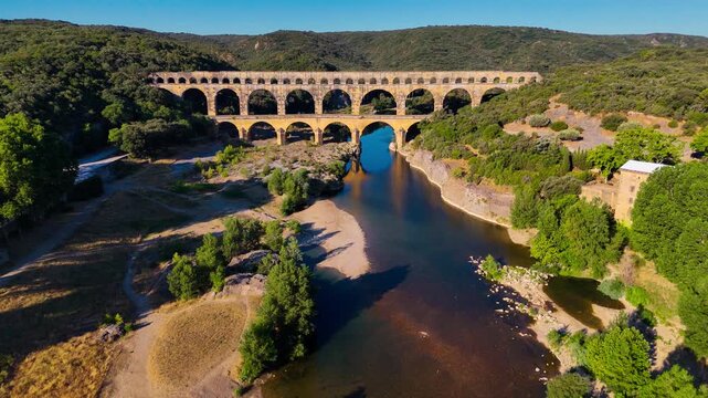 Aerial drone view of the Pont du Gard, the tallest surviving ancient Roman aqueduct from the 1st century with three tiers of arches, France. High quality 4k footage