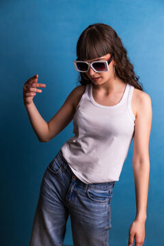 Woman dancing wearing sunglasses and tank top