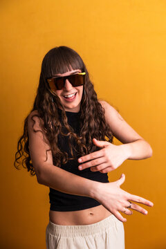 Young woman dancer performing urban moves with sunglasses