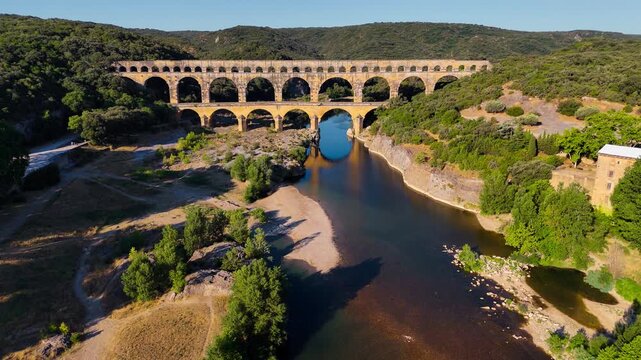 Aerial drone view of the Pont du Gard, the tallest surviving ancient Roman aqueduct from the 1st century with three tiers of arches, France. High quality 4k footage