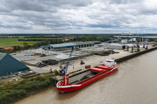 Red Cargo Ship Loading Steel Pipes at Goole Port