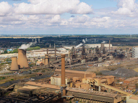 Steel Production Facility Operating at Tata Steel Plant in Scunthorpe Under a Bright Blue Cloudy Sky