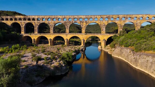 Aerial drone view of the Pont du Gard, the tallest surviving ancient Roman aqueduct from the 1st century with three tiers of arches, France. High quality 4k footage