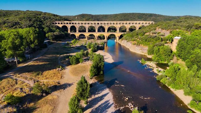 Aerial drone view of the Pont du Gard, the tallest surviving ancient Roman aqueduct from the 1st century with three tiers of arches, France. High quality 4k footage