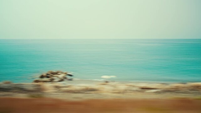 The Calabrian sea and coast in Italy, seen from a train during a summer journey