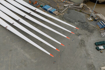 Fototapeta premium Wind Turbine Blades on a Busy Coastal Construction Site