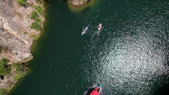 Pleasure boats in Matka Canyon Skopje, North Macedonia. Aerial Drone Footage of Boat Journey in Matka Canyon, Skopje, North Macedonia. Aerial panoramic drone view from above, top view from drone.  
