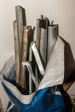 Stacked polypropylene bags filled with construction debris and demolition waste. Direct lighting and sharp focus on work textures for stock.