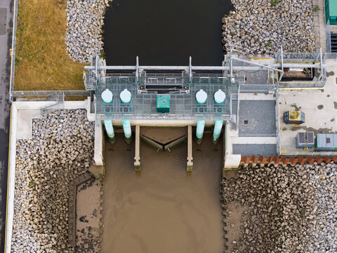 Concrete Flood Gate Controlling Water Flow Between Rocky Banks