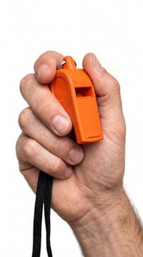 An orange whistle held by a person's hand, ready to signal
