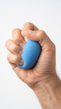 A close-up shot of a person's hand tightly squeezing a blue stress ball, representing the release of tension and frustration
