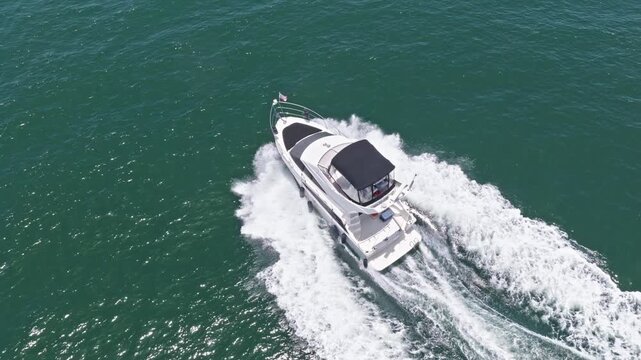 Elegant yacht at sea. Motorboat yacht sailing at sea. Motorboat aerial top view. Luxury boat motor yacht at sea. Yachting boat tourism. Luxury lifestyle. Vacation on summer