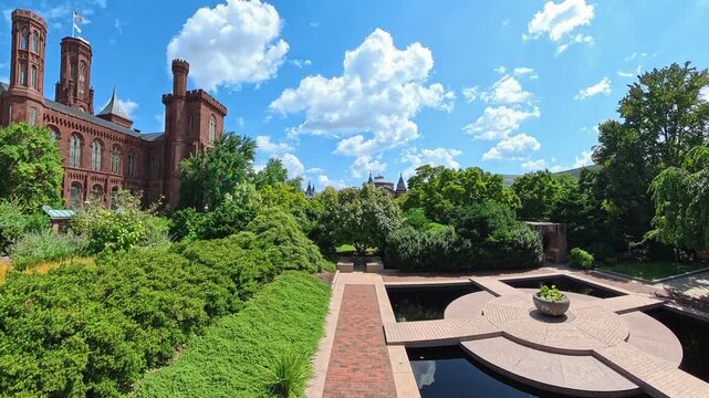 Camera circles a geometric reflecting pool in the garden beside Smithsonian Castle.