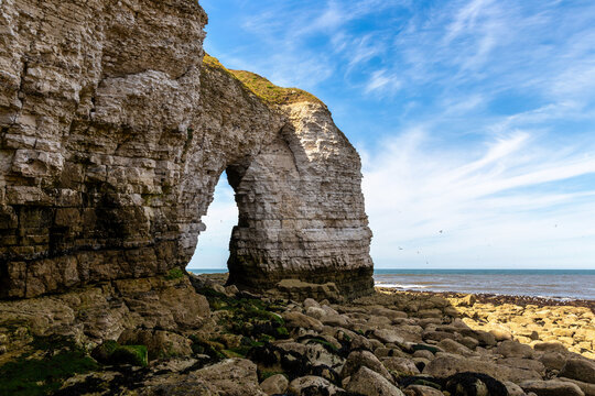 Natural white chalk sea arch at North Landing at Flamborough cliffs in England, UK