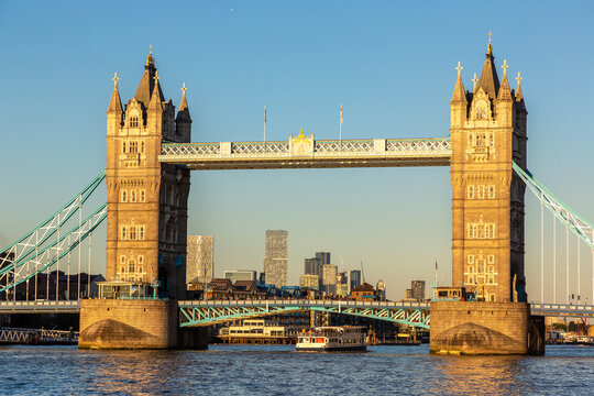 Tower Bridge Bascule and Suspension Bridge over River Thames at sunset in London, England, UK