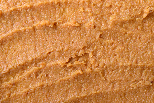 Close-up of miso paste texture background. Traditional fermented soybean seasoning for Japanese cuisine