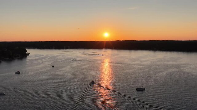  Aerial Sunset Over Lauderdale Lakes, Elkhorn, Wisconsin Golden sunset reflecting across the calm waters of Lauderdale Lakes near Elkhorn, Wisconsin, captured from an aerial drone perspective. Boats 