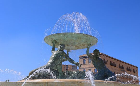 The Tritons&rsquo; Fountain is located in Floriana, Malta. It consists of three bronze Tritons holding up a large basin, balanced on a concentric base built. The Tritons&rsquo; Fountain