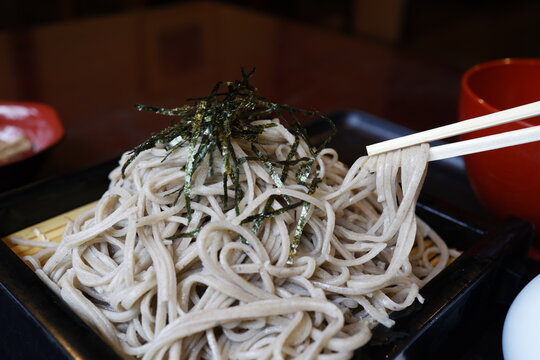 大盛りのざるそば。十割そば。海苔トッピング。黒い竹ざる。
