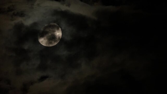 Tokyo,Japan - August 24, 2026: The half moon shining beyond thin clouds
