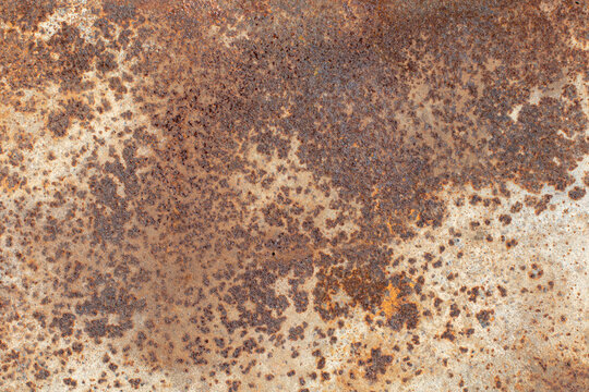 Close-up of heavily corroded old iron with dense rust spots and irregular patterns. Rough industrial texture for grunge backgrounds, construction and distressed designs.