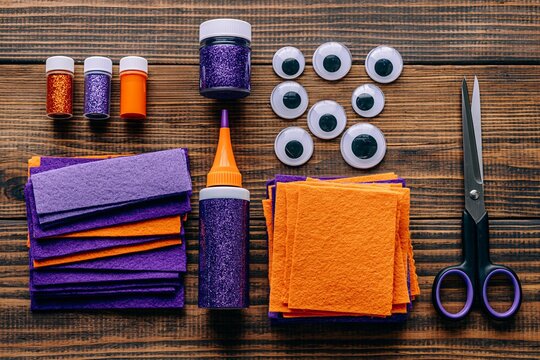 Halloween craft supplies laid out on a wooden table for a DIY project