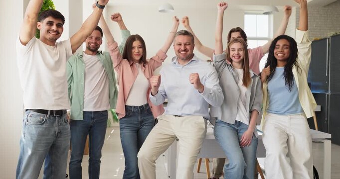 Teacher students celebration success teamwork cheering mentor. Diverse group raises hands in a modern classroom showing happiness and achievement. Symbol of learning success and teamwork.