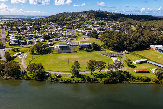Aerial view of Maclean Showground beside the Clarence River, with the town of Maclean and surrounding rural landscape visible in the background in the Northern Rivers region of NSW, Australia.
