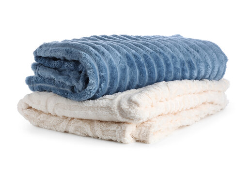 Cozy comfort and home textiles, stack of soft blue and beige fleece blankets for warmth and relaxation