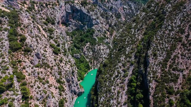 Aerial drone view of the turquoise Verdon River flowing through the Verdon Gorge river canyon in the Provence-Alpes-Cote d'Azur region of southeastern France. High quality 4k footage