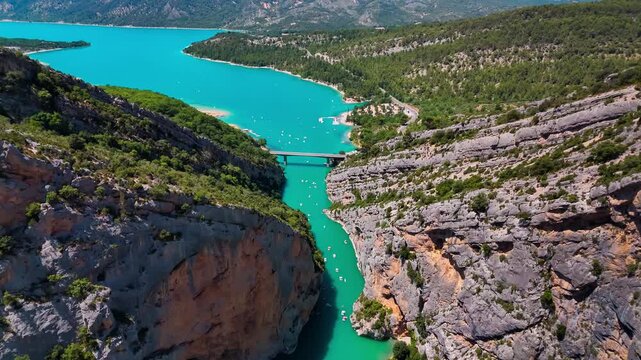 Aerial drone view of the turquoise Verdon River flowing through the Verdon Gorge river canyon in the Provence-Alpes-Cote d'Azur region of southeastern France. High quality 4k footage