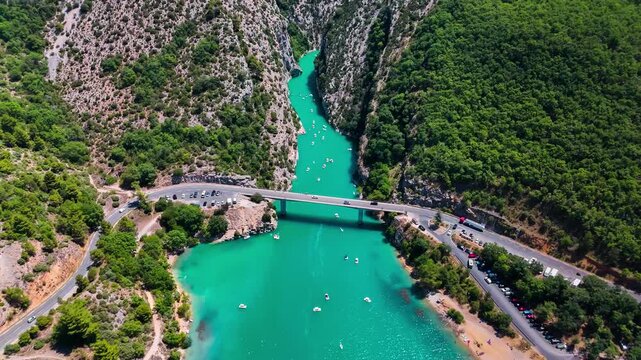 Aerial drone view of the turquoise Verdon River flowing through the Verdon Gorge river canyon in the Provence-Alpes-Cote d'Azur region of southeastern France. High quality 4k footage