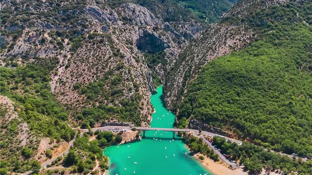 Aerial drone view of the turquoise Verdon River flowing through the Verdon Gorge river canyon in the Provence-Alpes-Cote d'Azur region of southeastern France. High quality 4k footage