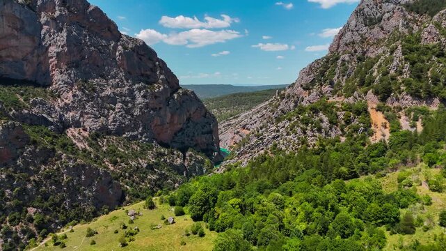 Aerial drone view of the turquoise Verdon River flowing through the Verdon Gorge river canyon in the Provence-Alpes-Cote d'Azur region of southeastern France. High quality 4k footage