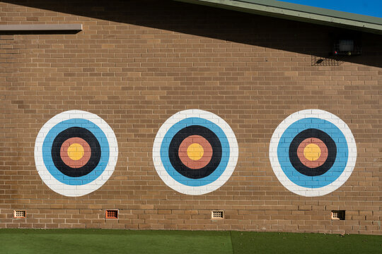 brick wall with three colorful targets