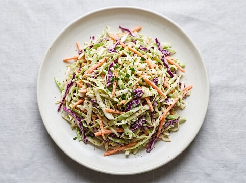 Fresh creamy coleslaw salad with shredded cabbage and carrots
