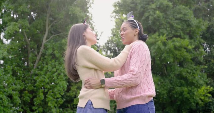 Merry Christmas headbands inspiring Diverse female friends hugging and smoothing collar in garden