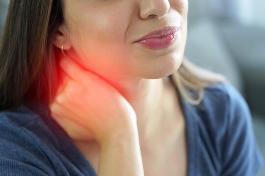 Detail of Unrecognizable Young Woman with Stiff Neck and Red Highlight Showing Pain Area