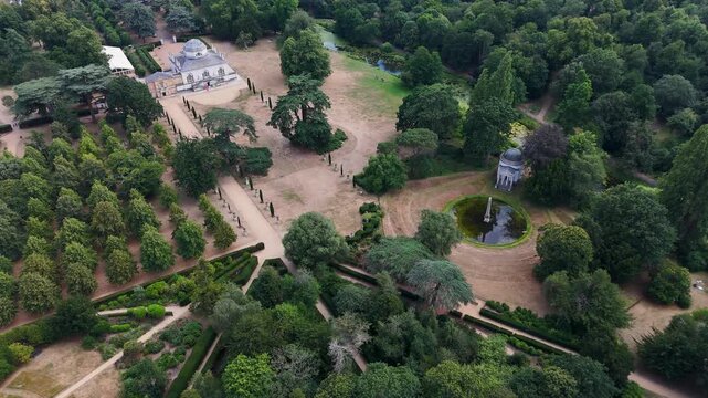 Historic landscaped parkland with a domed temple, ornamental water and avenues of trees, its lawns scorched by a prolonged heatwave