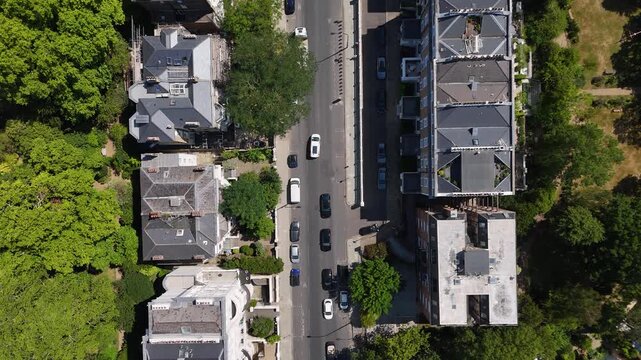 Top down view of a residential street with slate roofs, roof terraces and mature street trees in a prime district