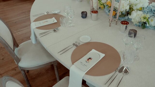 High angle view of luxury wedding banquet table setting with placemats and floral decor