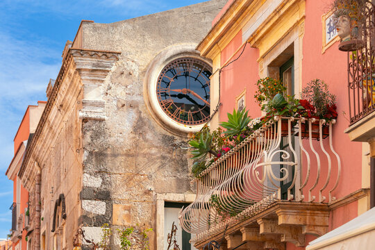 Historic Clock and Flowered Balcony in Taormina, Sicily, Italy