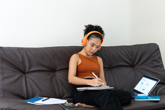 Young woman working remotely from home couch